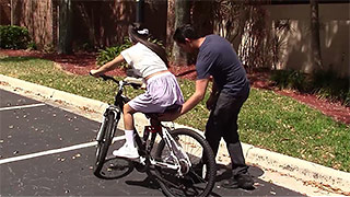 Dazzling teen bicyclist is riding not a bike 